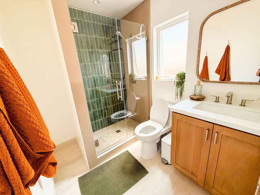 Finished bathroom remodel with tiled wet area and vanity